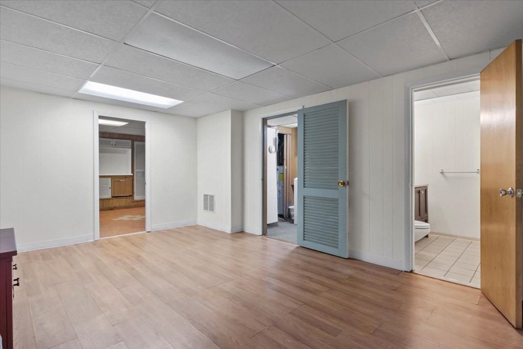 51 Joan Road Boston, MA 02136 - Photo 32 of 42 a view of an empty room with wooden floor and a bathroom