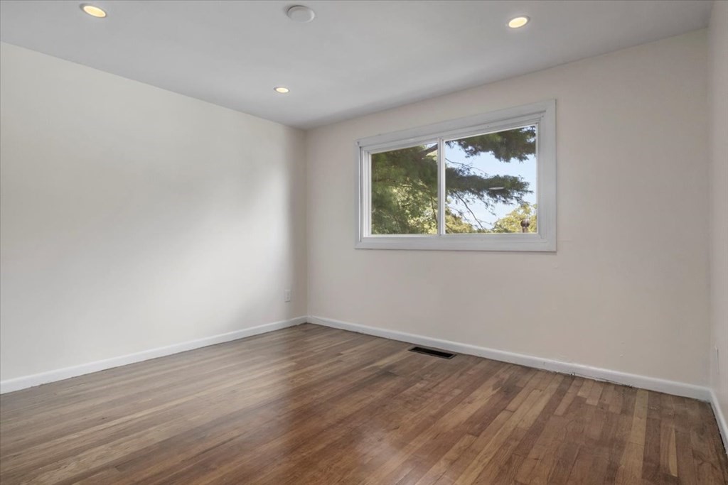51 Joan Road Boston, MA 02136 - Photo 7 of 42 a view of an empty room with wooden floor and a window