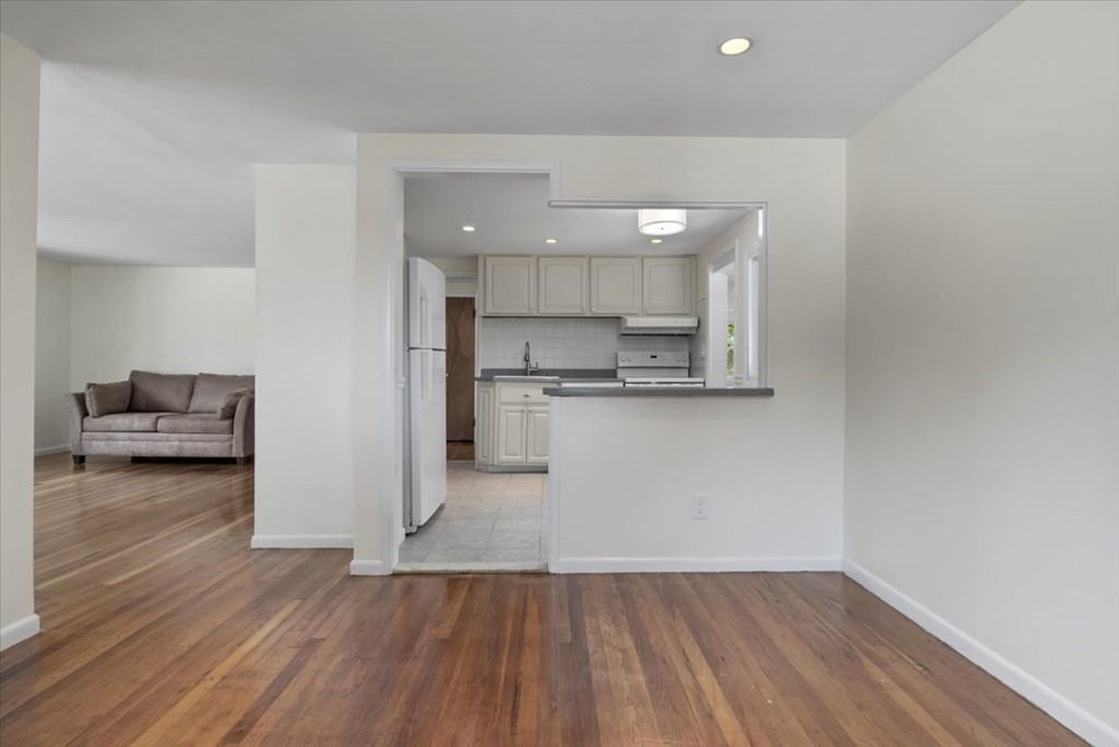 51 Joan Road Boston, MA 02136 - Photo 8 of 42 a view of kitchen with cabinets and wooden floor