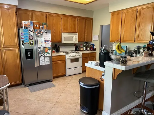 a kitchen with a refrigerator sink and stove top oven