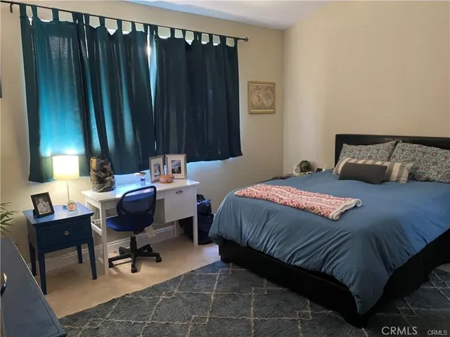 a bedroom that has a bed and a chair in it