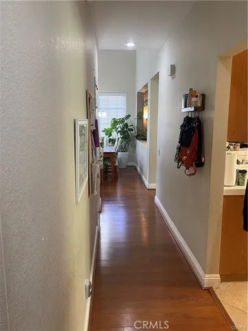 a view of hallway with furniture and wooden floor