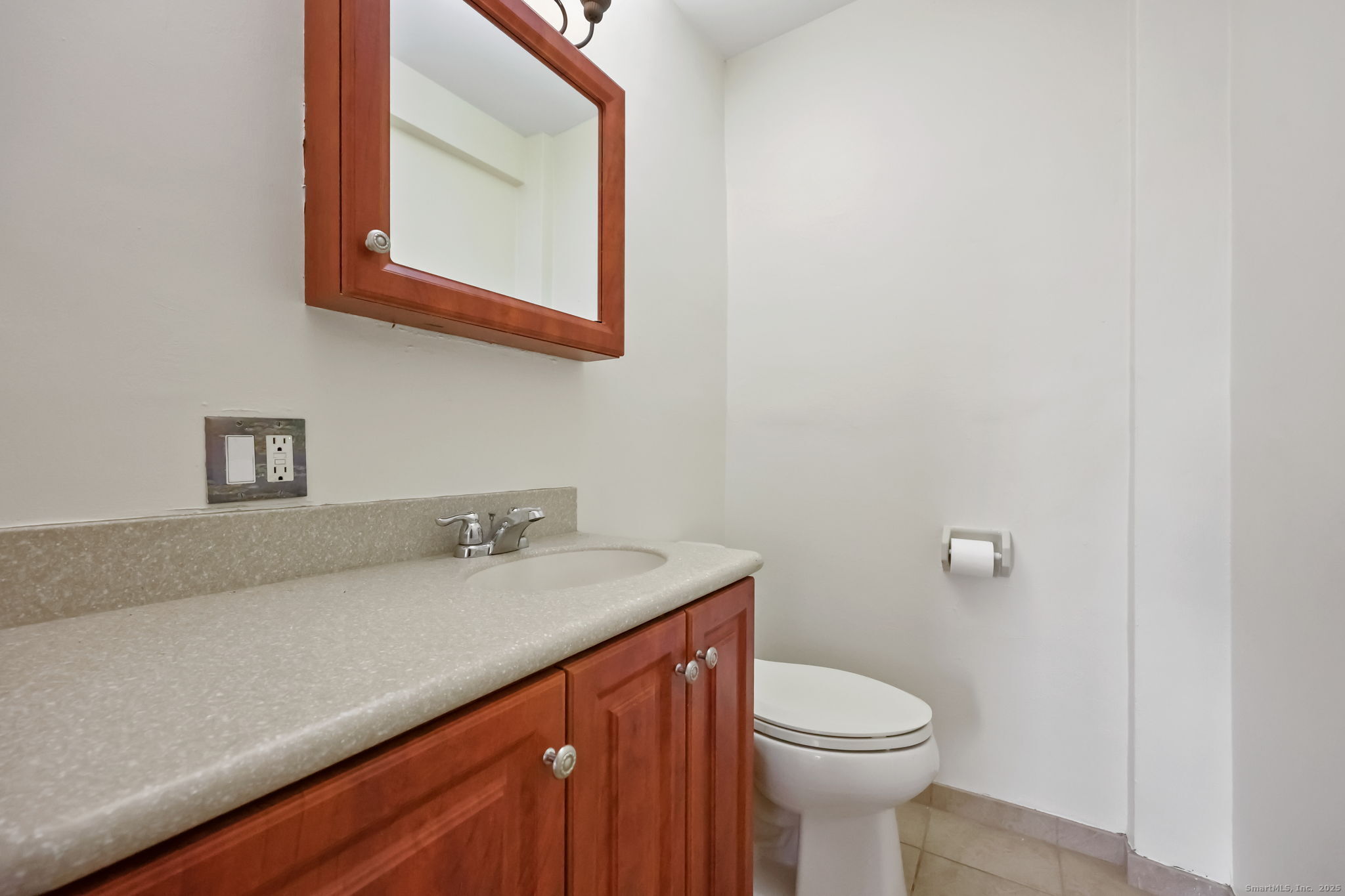 46 Prospect Avenue, Unit 1C Norwalk, CT 06850 - Photo 21 of 24 a bathroom with a granite countertop toilet sink and mirror