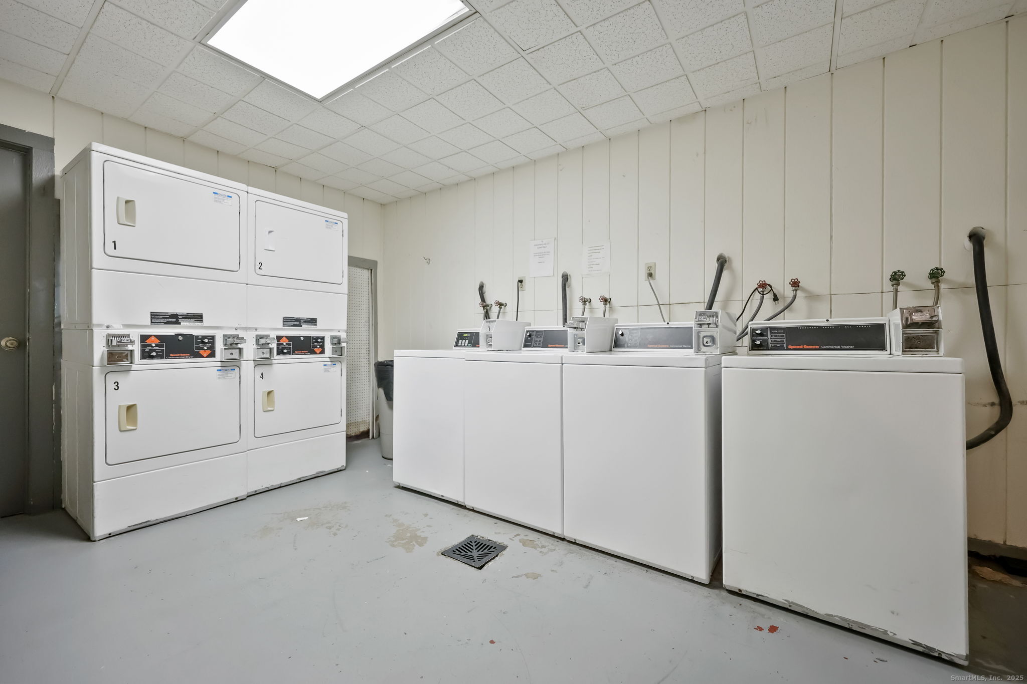 46 Prospect Avenue, Unit 1C Norwalk, CT 06850 - Photo 22 of 24 a utility room with cabinets washer and dryer