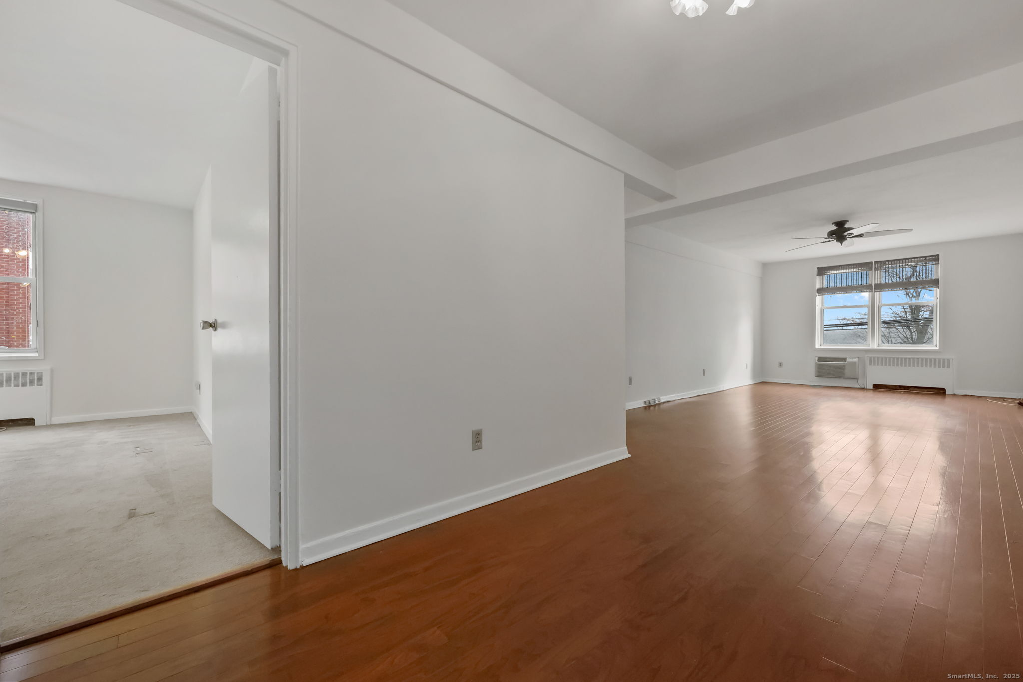46 Prospect Avenue, Unit 1C Norwalk, CT 06850 - Photo 4 of 24 an empty room with wooden floor and windows