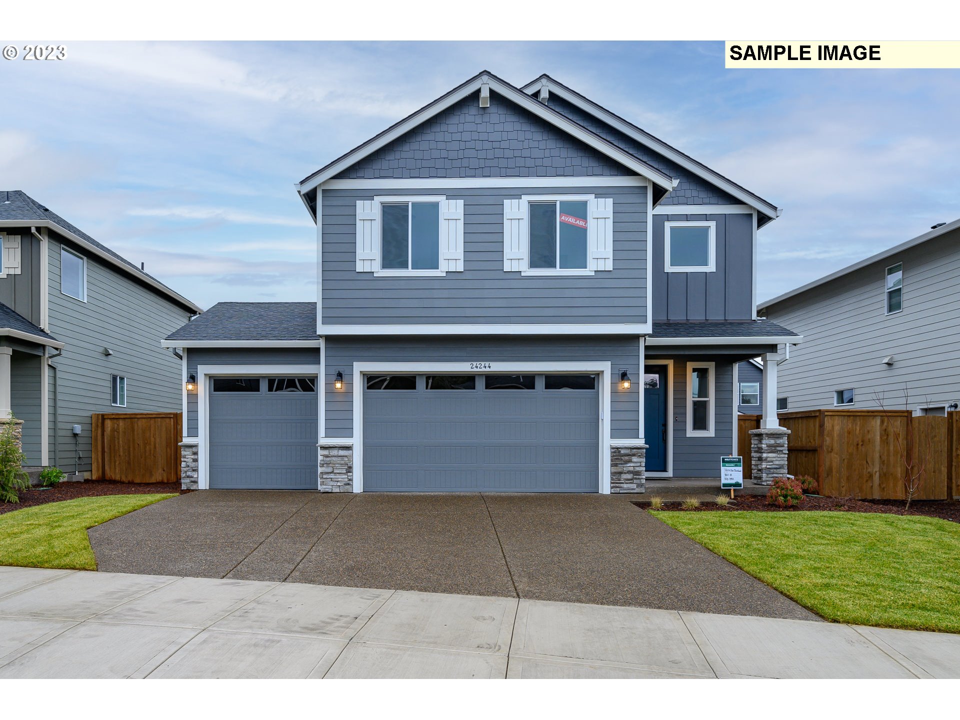 8843 North 3rd Circle, Unit 77 Ridgefield, WA 98642 - Photo 1 of 32 a front view of a house with a yard and garage