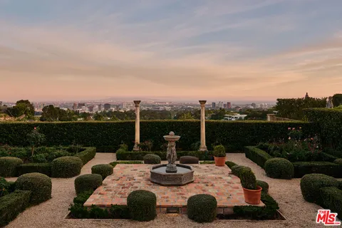 a view of a roof deck with couches and sky view