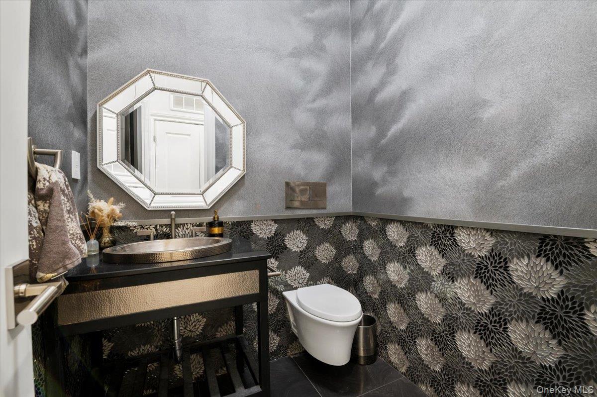 335 Summit Avenue Cedarhurst, NY 11516 - Photo 16 of 43 a bathroom with a toilet sink and mirror