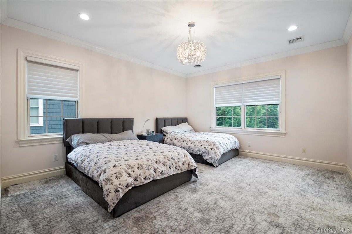 335 Summit Avenue Cedarhurst, NY 11516 - Photo 22 of 43 a bedroom with two beds and a large window