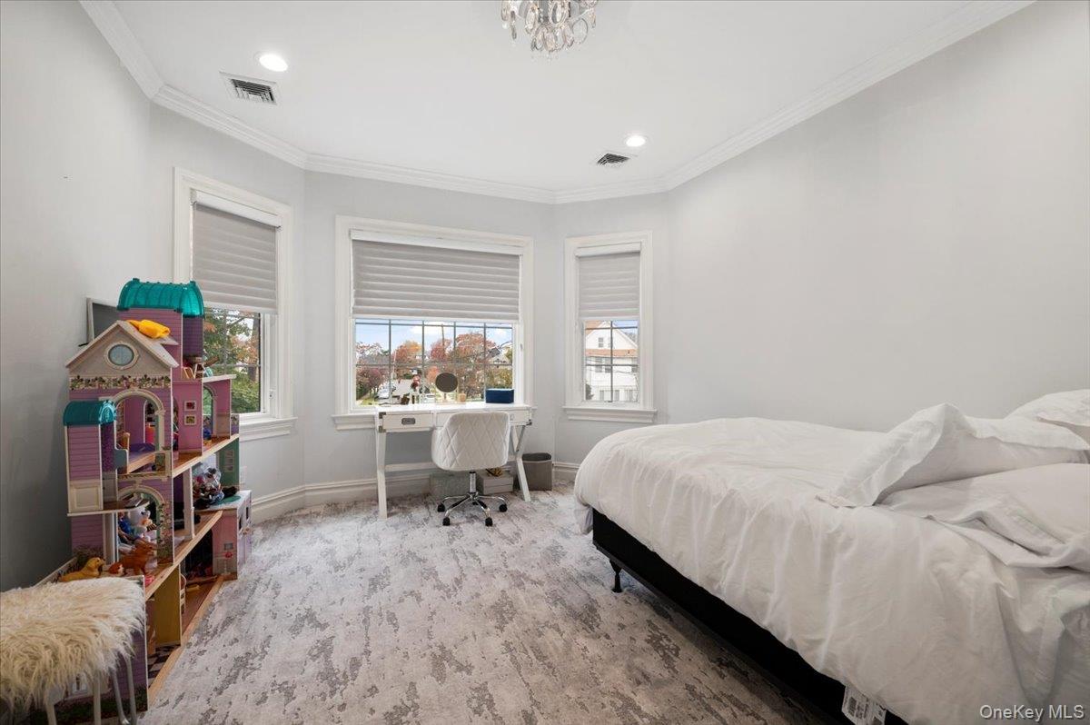 335 Summit Avenue Cedarhurst, NY 11516 - Photo 26 of 43 a bed room with a bed and a chair