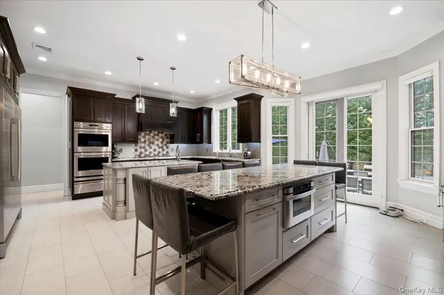 a kitchen with stainless steel appliances granite countertop a stove and a sink