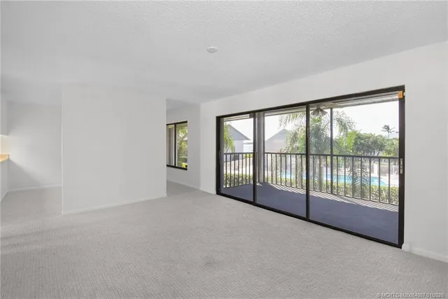 a view of an empty room and a window