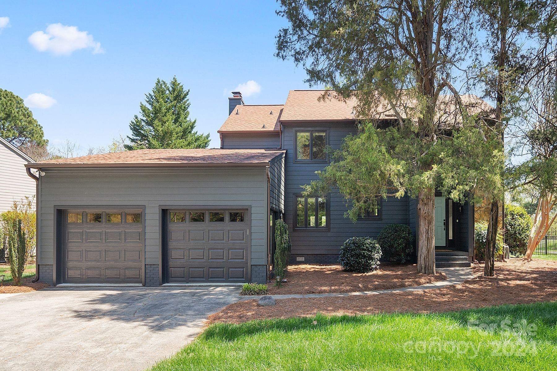 4201 Rounding Run Road Charlotte, NC 28277 - Photo 1 of 37 a front view of a house with a yard and garage
