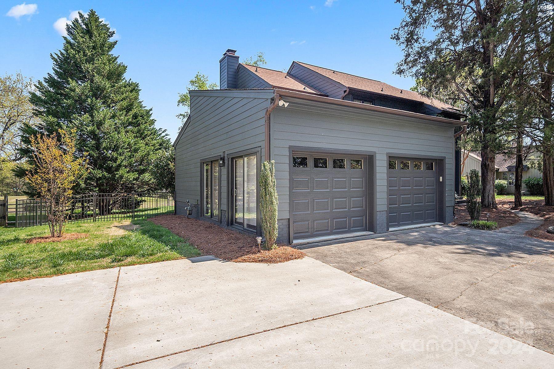 4201 Rounding Run Road Charlotte, NC 28277 - Photo 2 of 37 a front view of a house with a yard and garage
