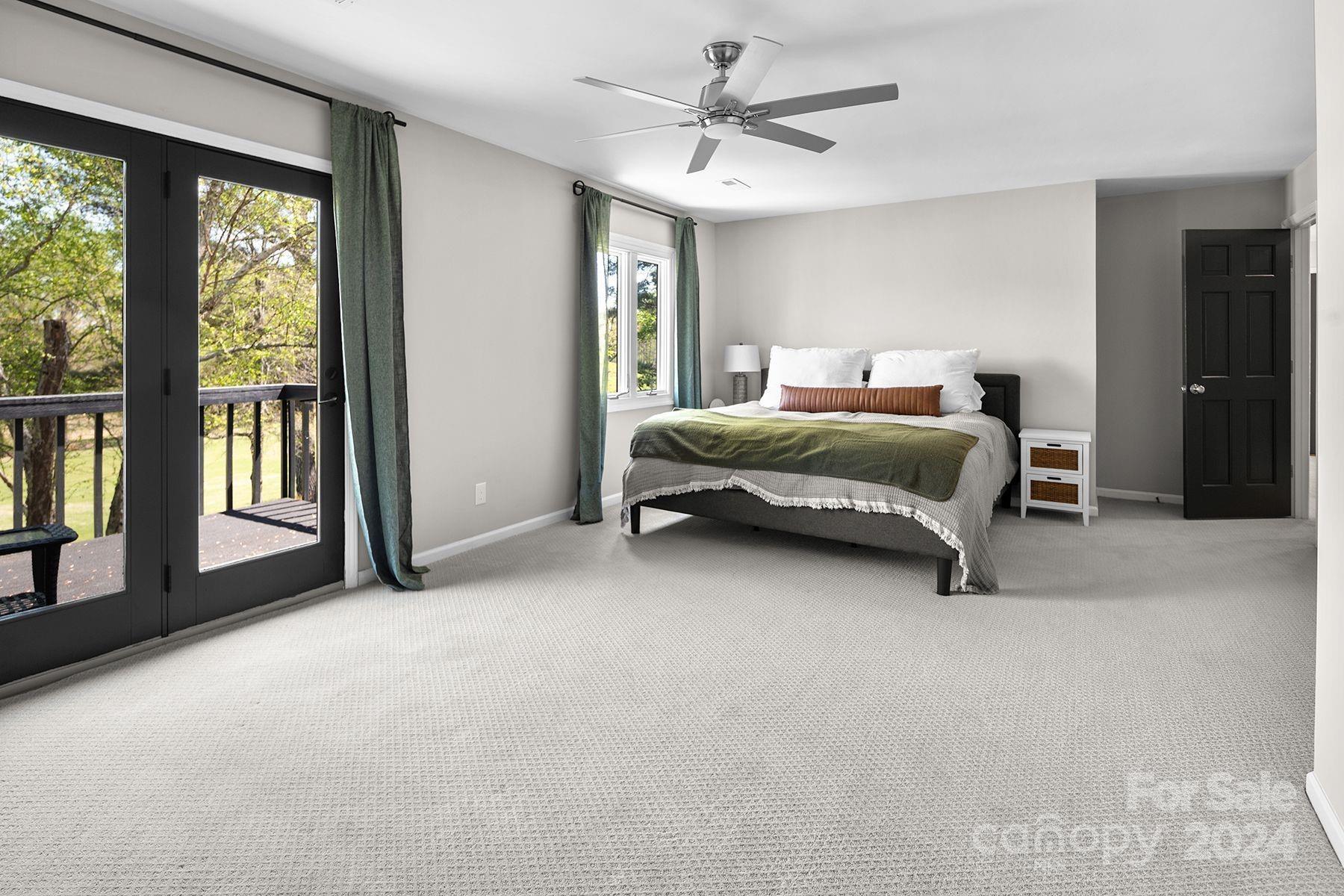 4201 Rounding Run Road Charlotte, NC 28277 - Photo 23 of 37 a spacious bedroom with a bed a chandelier and large window