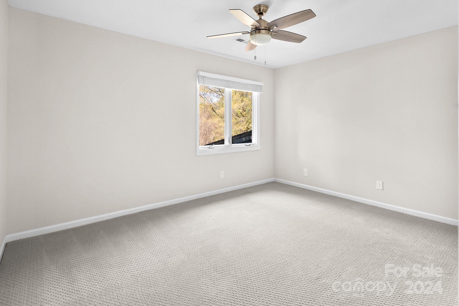 4201 Rounding Run Road Charlotte, NC 28277 - Photo 29 of 37 an empty room with windows and fan