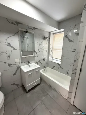 a bathroom with a sink a toilet and bathtub