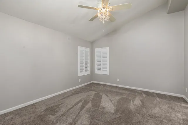 a bathroom with a granite countertop sink and a toilet