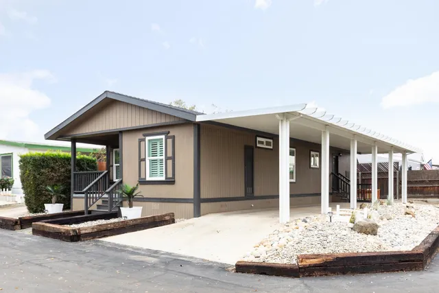 a front view of a house with glass windows and glass door