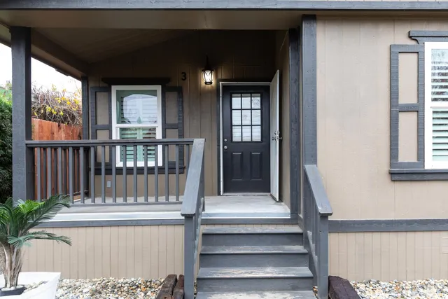 an empty room with fan and windows