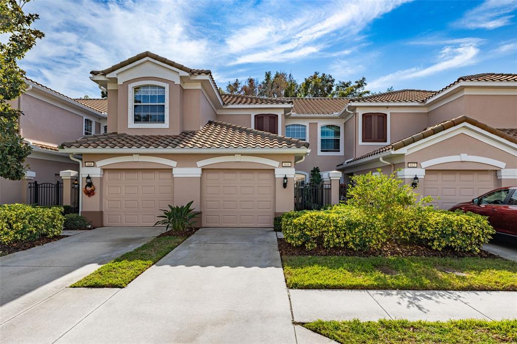 a front view of a house with a yard and garage