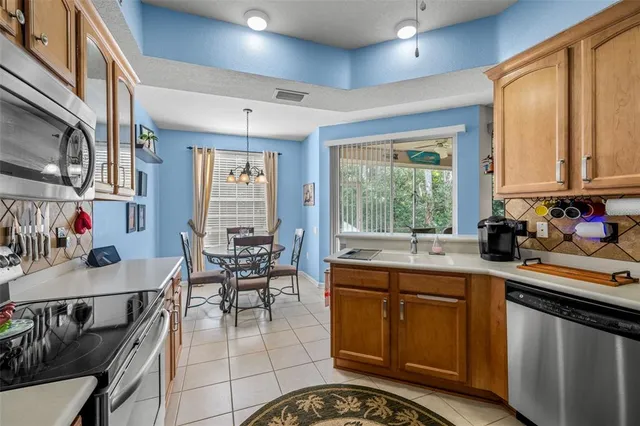 a kitchen with a sink stove and cabinets