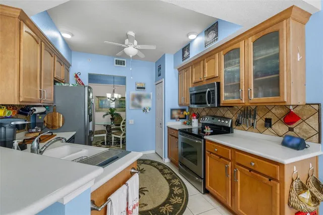 a kitchen that has a lot of cabinets a sink and appliances in it
