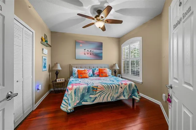 a bedroom with a bed table and a window