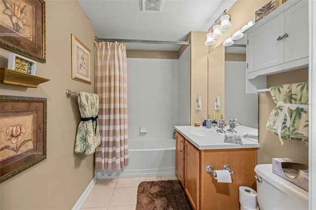 a bathroom with a sink a toilet and shower curtain
