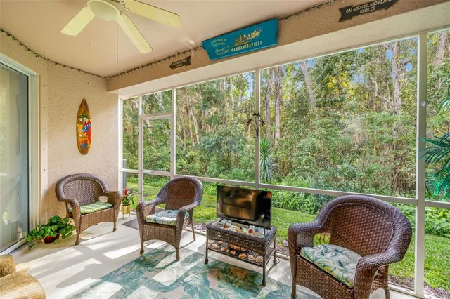 a living room with furniture and a floor to ceiling window