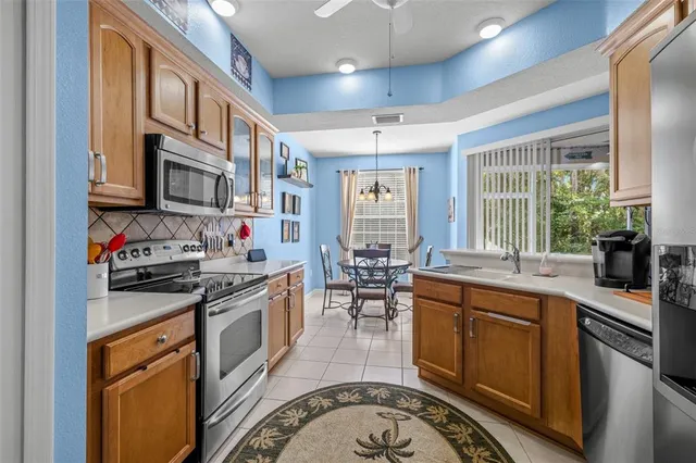 a kitchen with stainless steel appliances granite countertop a stove and cabinets