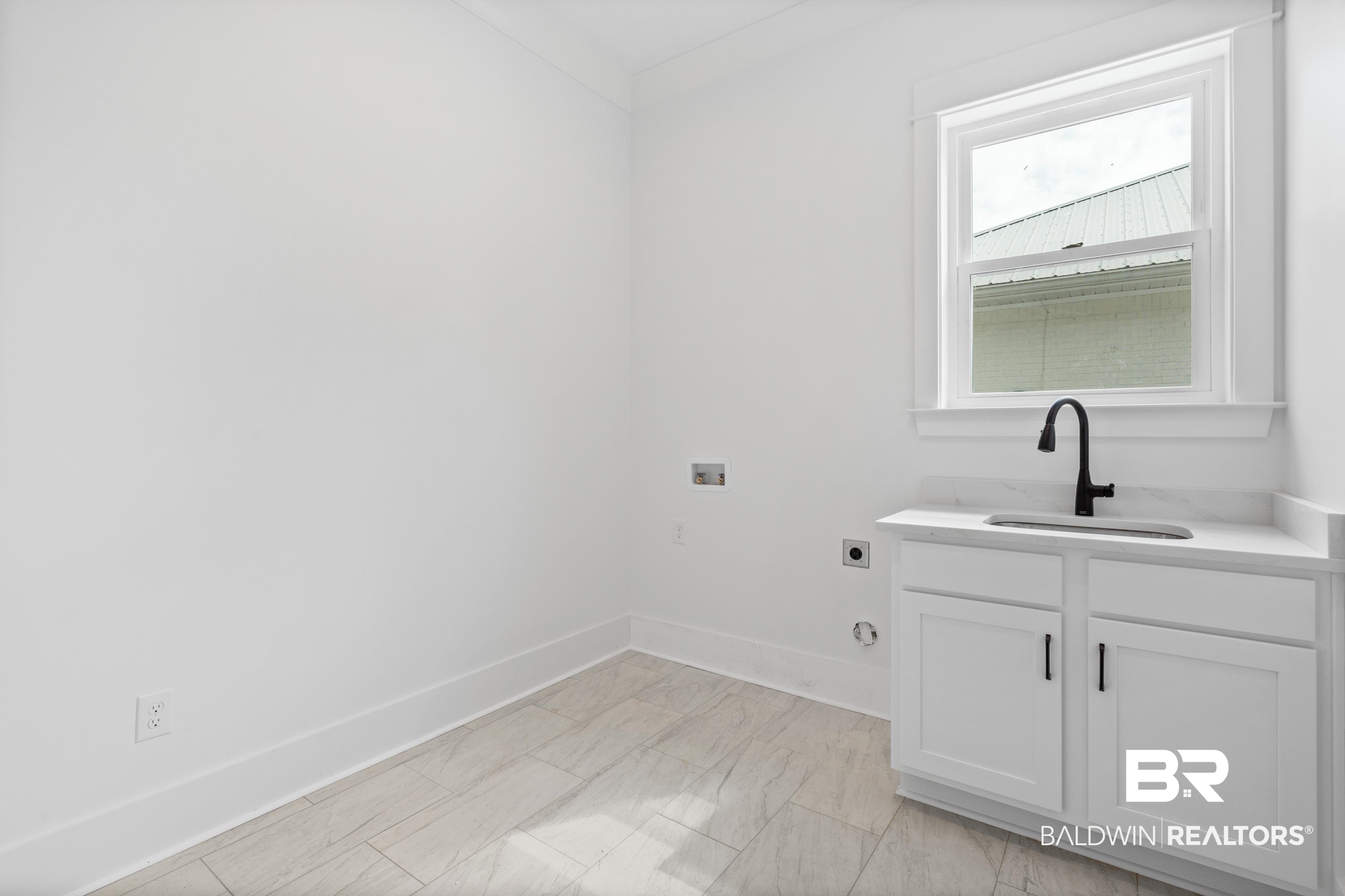 30650 Ono N Loop West Orange Beach, AL 36561 - Photo 32 of 38 Washroom with electric dryer hookup, hookup for a washing machine, baseboards, and cabinet space