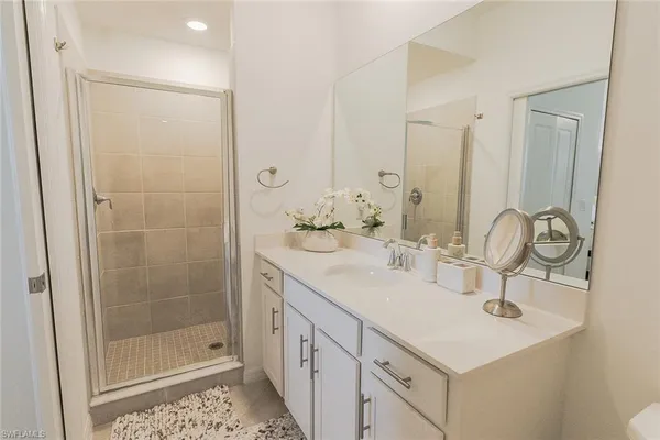 a bathroom with double sink and a mirror