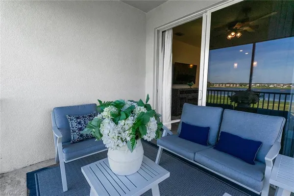 a living room with furniture flowerpot and a potted plant
