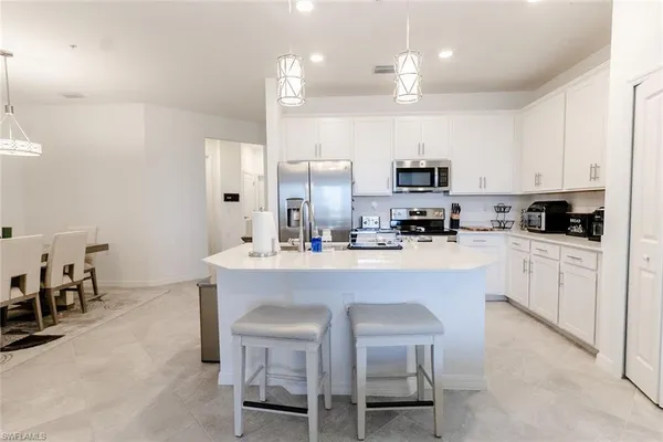 a kitchen with cabinets a sink and appliances
