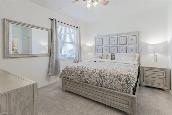 a bedroom with a large bed and a chandelier