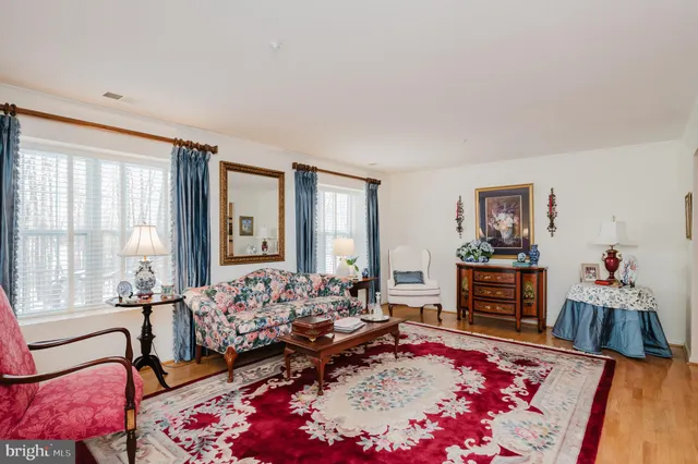 a kitchen with stainless steel appliances granite countertop a sink dishwasher stove and refrigerator with wooden floor