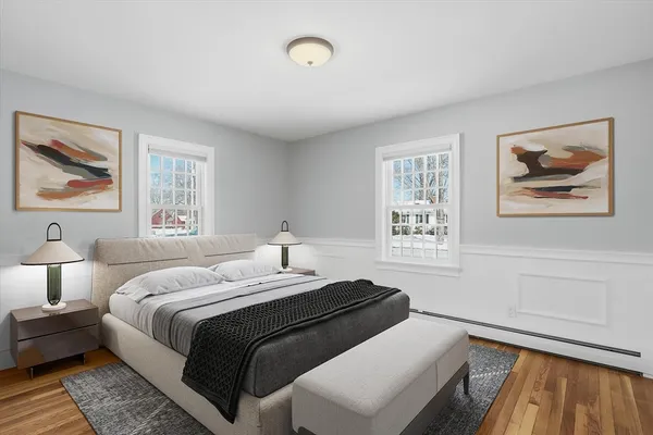 a bedroom with a bed and a painting on the wall