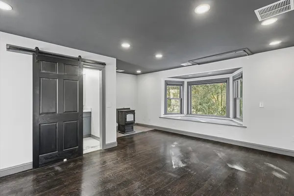 an empty room with windows and closet