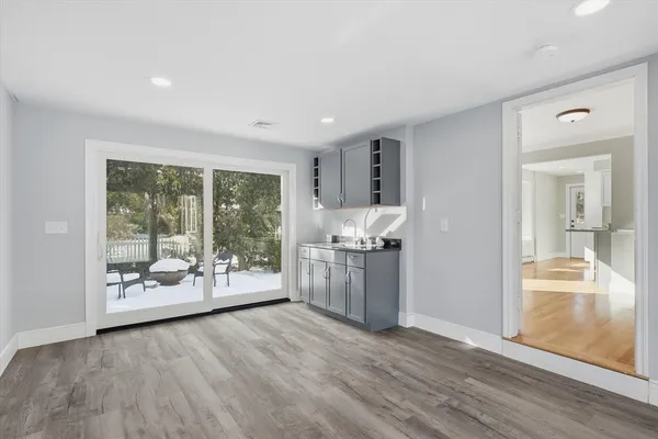 a room with wooden floor and white doors