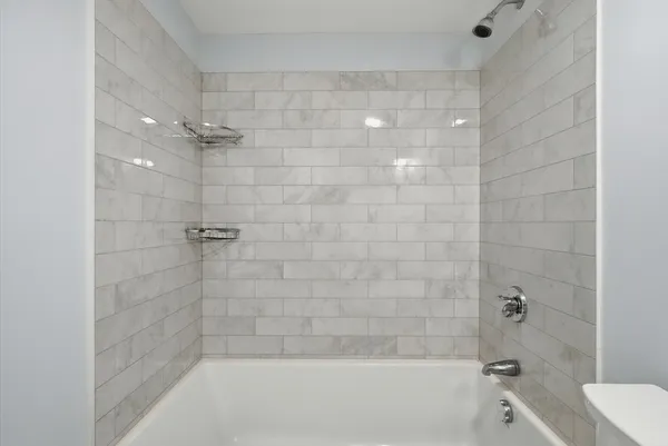 a bathroom with a shower and toilet