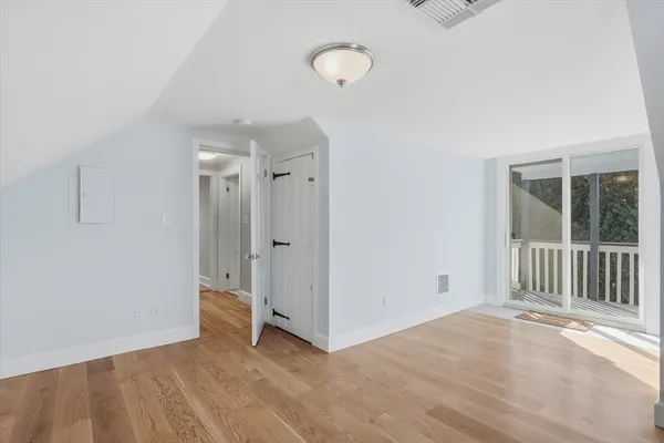 a view of a room with wooden floor and window