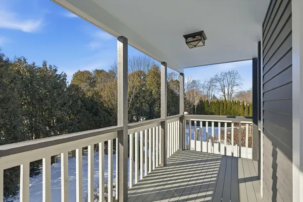 a view of a balcony with wooden floor and fence