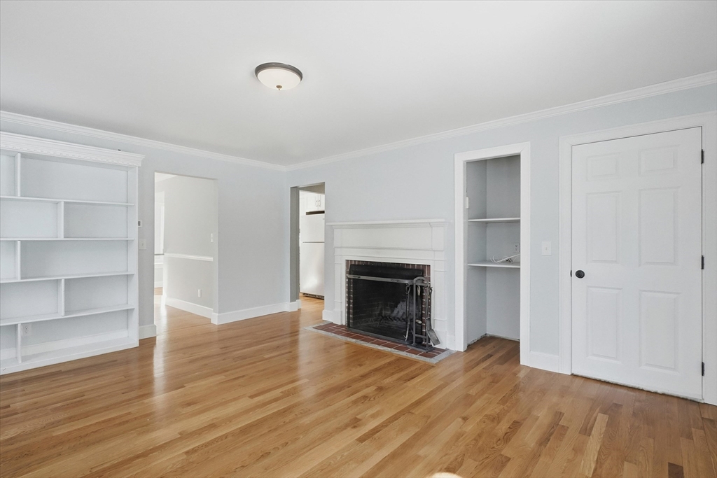 11 West Bradstreet Road North Andover, MA 01845 - Photo 3 of 42 a view of an empty room with wooden floor fireplace and a window