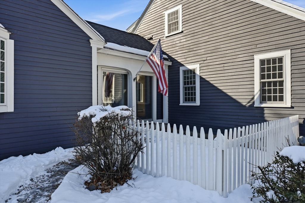 11 West Bradstreet Road North Andover, MA 01845 - Photo 33 of 42 a front view of a house with a large window and flower plants