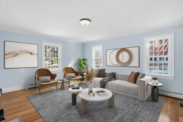 a living room with furniture and wooden floor