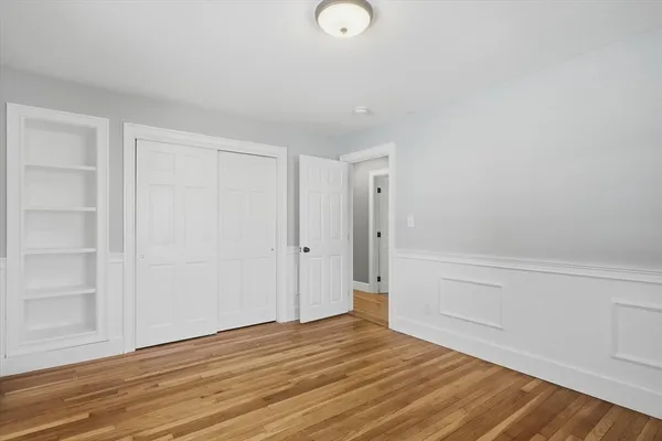 a view of an empty room and wooden floor