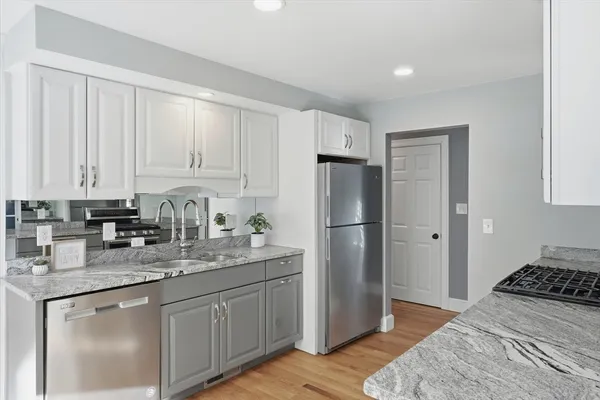 a kitchen with stainless steel appliances granite countertop a refrigerator sink and cabinets