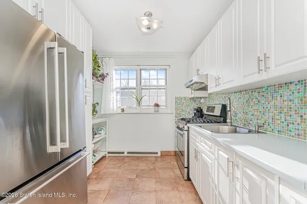 a kitchen with a refrigerator and a sink