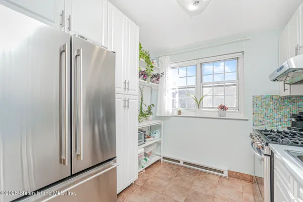a kitchen with stainless steel appliances granite countertop a refrigerator and a stove